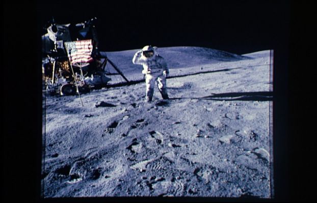 AS 16-113-18341 - Saluting the Flag
Mentre viene reso omaggio alla Bandiera, possiamo finalmente dare una buona occhiata alla superficie della Luna. Effettivamente la zona di allunaggio è abbastanza liscia e fortemente polverosa (guardate la profondità delle orme). Possiamo vedere anche dei sassi, di modeste dimensioni, sparsi intorno al LM. La tuta dell'astronauta appare già molto sporca di polvere color grigio scuro che arriva sino all'altezza delle ginocchia. 
La maggiore pendenza (solo apparente) del LM dipende dal fatto che la ripresa è stata effettuata inclinando la fotocamera.
Parole chiave: Postcards from the Moon