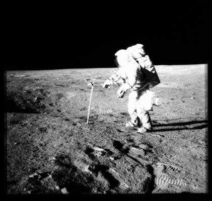AS 12-49-7286 - Working at Halo
133:25:41 MT - Al is hammering a double core tube at a geology stop near Halo Crater. He has driven in all of the lower section and most of the upper by this time. The crater beyond the core tube is not Halo. Note that Al is using the flat of the hammer. Because of the stiffness of the suit, it is difficult to control the swing and, by using the flat, he is more certain of actually hitting the top of the extension handle. Al is wearing a "saddlebag" on his left hip and, beyond it, we can see part of the Hand Tool Carrier or HTC. We can see good detail of Al's camera handle and trigger which, unbeknownst to the crew, has started to come loose.

Parole chiave: Lunar Surface - Astronaut at work