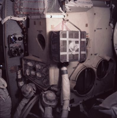 AS 13-62-8929 - The "home-made" Air-Cleaning Device (1)
Caption NASA originale:"Inflight photo of the device constructed by the crew from duct tape, maps and other materials they had on hand as per instructions provided by Houston. 
This device allowed use of box-shaped Command Module Lithium Hydroxide canisters in conjunction with the LM Environmental Control System, which is the large white unit that fills most of the frame. 
The LM LiOH canisters were cylindrical in shape and fit into the receptacles at the lower left". 
Parole chiave: Inside the Spacecrafts - Apollo 13