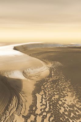 Chasma Boreale (2)
Tapering from a width of 120 Km (75 miles) at its mouth, Chasma Boreale is only about 35 Km (22 miles) wide here. The cliffs on the Northern (top) and Eastern (right) sides of the image rise about 1400 meters (4600 feet) above the base. On the inside walls of this gigantic amphitheater are stacked layers of ice, while on its floor lie a dark sheet of what is likely frozen sand and a horde of sand dunes marching down-canyon under the winds' direction.
Chasma Boreale is so dramatic a feature that it forms part of a proposed martian "Polar Park." Yet setting aside future tourist revenues, the canyon is rewarding scientists today with glimpses into the history of the martian climate.
Parole chiave: Artistic Visions of the Solar System