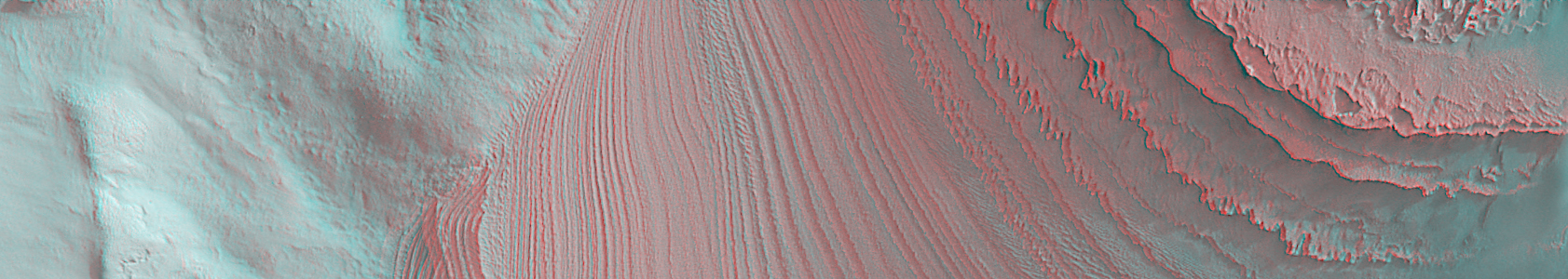 Layers of Galle Crater (3D - credits: NASA/JPL/MSSS)
Caption NASA:"This is a 3-D stereo anaglyph showing layers in Galle Crater. This anaglyph uses two MGS-MOC images acquired at slightly different viewing angles: MOC images E22-01557 and M14-02055. Owing to the specifics of the viewing geometry, the image is tilted on its side, relative to the mosaic shown in the 15 June 2006 release. In other words, in this image, North is toward the right and West is up. This anaglyph, when viewed in conjunction with the 15 June 2006 mosaic of these layers, provides a more complete sense of the cross-cutting relations between layers in the mound located in southern Galle (Happy Face) Crater. The layers are part of a mound of sedimentary rock in southern Galle — a remnant of a once more-extensive deposit of sedimentary material in this south mid-latitude impact basin. 
 
Location near: 52,3° South Lat. and 30,1° West Long.
Image width: ~7,3 Km (~4,5 mi)  
Illumination from: upper right  
Anaglyph from MOC images: E22-01557 and M14-02055  
Parole chiave: Mars from orbit - Craters - Galle Crater