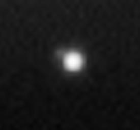 Earth, from Saturn's Space (2)
This magnified view of the image taken through the clear filter (monochrome) shows the Moon as a dim protrusion to the upper left of Earth. Seen from the Outer Solar System through Cassini's cameras, the entire expanse of direct human experience, so far, is nothing more than a few pixels across. Earth no longer holds the distinction of being our Solar System's only "water world", as several other bodies suggest the possibility that they too harbor liquid water beneath their surfaces. The Saturnian moon, Enceladus, is among them, and is also captured on the left in this image, with its plume of water ice particles and swathed in the blue E-Ring which it creates. Delicate fingers of material extend from the active moon into the E-Ring. The narrow and tenuous G-Ring and the Main Rings are seen at the right. The view looks down from about 15° above the un-illuminated side of the Rings.

Images taken using red, green and blue spectral filters were combined to create this view. The image was taken by the Cassini spacecraft wide-angle camera on Sept. 15, 2006, at a distance of approx. 2,1 MKM (about 1,3 MMs) from Saturn and at a sun-Saturn-spacecraft angle of almost 179°. 
Image scale is roughly 129 Km (about 80 miles) per pixel. 

At this time, Cassini was nearly 1,5 BKM (about 930 MMs) from Earth. 

Parole chiave: Earth from Space