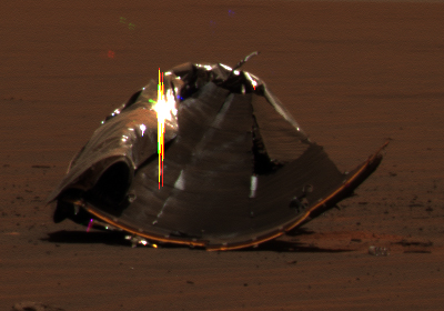 The Heat-Shield in "approximately true colors" on Sol 325
Caption NASA originale:"The picture features the main Heat-Shield debris when Opportunity was approximately 40 meters (about 131 feet) away from it. Many rover-team engineers were taken aback when they realized the Heat-Shield had inverted, or turned itself inside out. The height of the pictured debris is about 1.3 meters (about 4.3 feet). The original diameter was 2.65 meters (8.7 feet), though it has obviously been deformed. 
The fact that the Heat-Shield is now inside out makes it more challenging to evaluate the state of the thermal protection system that is now on the inside. In coming sols, Opportunity will investigate the debris with its microscopic imager". Lo Scudo Termico, quindi, a detta del Controllo Missione, durante la caduta su Marte si sarebbe "rivoltato come un guanto". Scusateci, ma fra le tante sciocchezze che la NASA, ogni giorno, ci offre su piatti d'argento, questa ci sembra davvero da incorniciare. 
O forse è colpa nostra che non riusciamo a capire quello che cercano di dirci...
Parole chiave: The Heat-Shield
