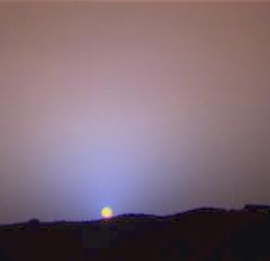 Sunset on Mars - Sol 24 (True Colors; credits: NASA/JPL)
Caption NASA:"This is a close-up of the Sunset on Sol 24 as seen by the Imager for Mars Pathfinder. The red sky in the background and the blue around the Sun are approximately as they would appear to the human eye. The color of the Sun itself is not correct - the Sun was overexposed in each of the 3 color images that were used to make this picture. The true color of the Sun itself may be near white or slightly bluish".
Parole chiave: Postcards from Mars