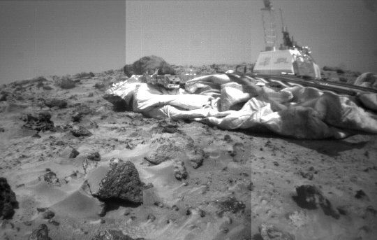 Sagan Memorial Station - Sol 39
Caption NASA originale:"This is one of the best images of the Sagan Memorial Station taken by the Soujourner Rover. Looking out from the Rock Garden, the Camera Mast and High Gain Antenna can clearly be seen above the American flag and the Jet Propulsion Laboratory logo".
Parole chiave: Postcard from Mars - Ares Vallis (Carl Sagan Memorial Station)