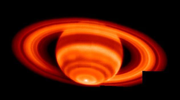 Saturn's temperature emissions (upper troposphere)
Caption NASA originale:"This is the sharpest image of Saturn's temperature emissions taken from the ground; it is a mosaic of 35 individual exposures made at the W.M. Keck I Observatory, Mauna Kea, Hawaii on Feb. 4, 2004. 
The images to create this mosaic were taken with infrared radiation. The mosaic was taken at a wavelength near 17,65 microns and is sensitive to temperatures in Saturn's upper troposphere. The prominent hot spot at the bottom of the image is right at Saturn's South Pole. The warming of the Southern Hemisphere was expected, as Saturn was just past Southern Summer Solstice, but the abrupt changes in temperature with latitude were NOT expected. The tropospheric temperature increases toward the pole abruptly near 70° latitude from 88° to 89° Kelvin (-301° to -299° Fahrenheit) and then to 91° Kelvin (-296° degrees Fahrenheit) right at the Pole. Ring particles are not at a uniform temperature: they are obviously coldest just after having cooled down in Saturn's shadow (lower left)". 
Parole chiave: From Earth Images