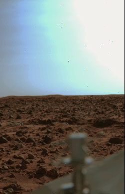 From the "Viking Archive" - Viking 1: late afternoon
This is a Viking One late afternoon view on a fairly clear day. The bright sky near the Sun is apparently a lighter bluish color due to 'forward scattering'. The blue seen here is probably more camera induced than real. On Mars the 'Raleigh Scattering' which colors our sky blue is greatly diminished by the low atmospheric pressure. Although no obvious clouds were reported, The horizontal texture in the sky to the left of the overexposed region might just be some weak cloud detail.
Parole chiave: Martian Sky - afternoon