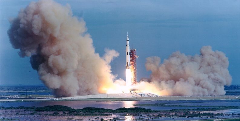 The Launch of Apollo 15
The "ORIGINAL" Apollo Time-Table (from Apollo 13)
APOLLO 13. March, 1970. Land in Fra Mauro formation of flat highlands, stay about 22 hours. Collect soil and rock from an old area relatively untouched by what many believed were ancient floods or volcanoes.  
APOLLO 14. July, 1970. Land in Censorinus Crater area for a stay of about 22 hours. Investigate craters, possibly carved in Moon's surface by meteors.  
APOLLO 15. November, 1970. Land in Littrow area of volcano-like projections, remain about 22 hours. Attempt a pinpoint landing on an exact, pre-selected target.  
APOLLO 16. March, 1971. Descend to Crater Copernicus, remaining for about 70 hours. Extract from crater and high-rising column within formation rocks believed to be from far below the lunar surface.  
APOLLO 17. Late in 1971. Land near rugged highland crater Tycho for stay of about 70 hours. Test first moon "rover" vehicle.  
APOLLO 18. Early 1972. Land in Marius Hills, remain about 70 hours. Collect soil and rock samples from volcanic-like domes and valleys between.  
APOLLO 19. Middle or late 1972. Land deep in Schroeter's Valley, with about 70 hours on the surface. Attempt a descent into a deep crater to determine cause of mysterious "red flashes" seen there by astronomers.  
APOLLO 20. Late 1972 or early 1973. Land near the Hyginus Rill, a long, major canyon, for stay of about 70 hours. Investigate canyon for possible lunar core material.  
This timeline had been altered slightly even before the Apollo 13 mission, when in January, 1970, Apollo 20 was cancelled in order to reserve the last production Saturn V for use in launching the planned Skylab orbiting laboratory a few years later. This change shifted the planned Apollo 18 and 19 lunar missions to 1974 to follow Skylab, but further budget-cutting in late 1970 also resulted in the cancellation of Apollo 18 and 19.  

Parole chiave: Apollo 15 postcard