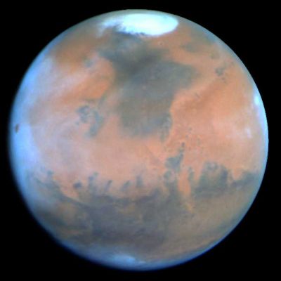 Mars: the Red Planet with "Blue Limbs"...
Mars Data and Statistics 
Mass (kg) = 6.421e+23 
Mass (Earth = 1) = 1.0745e-01 
Equatorial radius = 3.397,2 Km
Equatorial radius (Earth = 1) = 5.3264e-01 
Mean density (gm/cm^3) = 3,94 
Mean distance from the Sun = 227.940.000 Km
Mean distance from the Sun (Earth = 1) = 1,5237 
Rotational period (hours) = 24,6229 
Rotational period (days) = 1,025957 
Orbital period (days) = 686,98 
Mean orbital velocity = 24,13 Km per second
Tilt of axis = 25,19°
Orbital inclination = 1,850°
Equatorial surface gravity (m/sec^2) = 3,72 
Equatorial escape velocity = 5,02 Km per second
Magnitude (Vo) = - 2.01 
Minimum surface temperature = - 140°C 
Mean surface temperature = - 63°C 
Maximum surface temperature = + 35°C 
Atmospheric pressure (bars) = 0,007 
Atmospheric composition: Carbon Dioxide (C02) 95,2%; Nitrogen 2,7%; Argon 1,6%; Oxygen 0,13%; Carbon Monoxide 0,07%; Water 0,03%; Neon 0,00025%; Krypton 0,00003%
Parole chiave: Mars from Earth