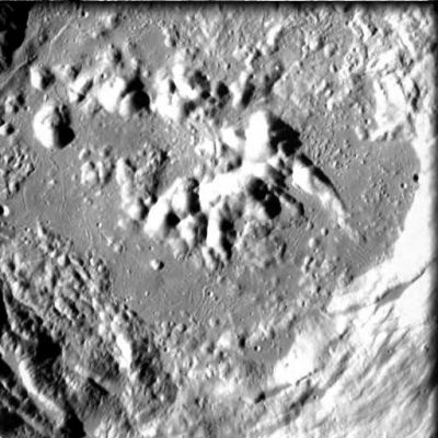 Zucchius Crater
This image of the central peaks of crater Zucchius was obtained by AMIE on 14 January 2006 from a distance of about 753 kilometres from the surface, with a ground resolution of 68 metres per pixel. 

The imaged area is centred at a latitude of 61.3° South and longitude 50.8° West. Zucchius is a prominent lunar impact crater located near the southwest limb. It is 66 kilometres in diameter, but due to SMART-1's proximity to the surface, the AMIE field of view covers only the central 35 kilometres of the crater in this image.

Because of its location, the crater appears oblong-shaped due to foreshortening.  It lies just to the south-southwest of the Segner crater, and northeast of the much larger Bailly walled-plain. To the southeast is the Bettinus crater, a formation only slightly larger than Zucchius.

Zucchius formed in the Copernican era, a period in the lunar planetary history that goes from 1200 million years ago to present times. Another example of craters from this period are Copernicus (about 800 milion years old) and Tycho (100 million years old).  Craters from the Copernican era show characteristic ejecta ray patterns - as craters age, ejecta rays darken due to weathering by the flowing solar wind. 

The hills near the centre of the image are the central peaks of the crater, features that form in large craters on the Moon. This type of feature is formed by the impact of a small asteroid onto the lunar surface. The surface is molten and, similarly to when a drop of water falls into a full cup of coffee, the hit surface bounces back and solidifies into the central peak.

The Zucchius crater is named after the Italian Mathematician and astronomer Niccolo Zucchi (1586-1670).

Parole chiave: The Moon from orbit - Craters (Zucchius)