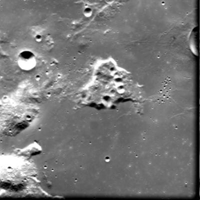Crater Gruithuisen-B and Gruithuisen Montes
Caption ESA originale:"This image, taken by the Advanced Moon Imaging Experiment (AMIE) on board ESA's SMART-1 spacecraft, shows the Gruithuisen Area on the Moon. 
AMIE obtained this image on 1 January 2006, from a distance of about 2154 Km from the surface, with a ground resolution of 195 mt per pixel. 
The area shown in the image is centred at a Latitude of 34.8º North and Longitude 40º West. 

The prominent bowl-shaped crater close to the left edge of the image is Gruithuisen-B. Gruithuisen itself is just visible at the right edge of the image. The mountains visible in the area are called Montes Gruithuisen. 
It is possible to note the large number of similar sized craters to the right of the centre of the image. They are so-called secondary craters, produced by ejecta particles from a large impact which fell back to the Moon".
Parole chiave: The Moon from orbit - Craters - Gruithuisen-B