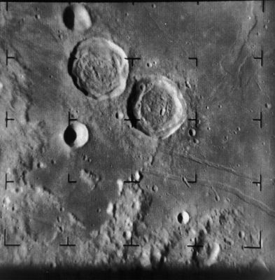 Ritter and Sabine Crater, from Ranger 8
Caption NASA originale:"Ranger 8 image of the Moon from 302 km. The image was taken on 20 February 1965 and 9:55 UT, two and a half minutes before the spacecraft impacted on the Lunar Surface. The two large craters at upper center are Ritter (above left) and Sabine, each about 30 Km in diameter. The Apollo 11 landing site is just off the right edge of the image at about 4:00. The image is about 130 Km across and north is up (Ranger 8, A030)".

Location & Time Information
Date/Time (UT): 1965-02-20 T 09:55:01
Distance/Range (km): 302.39
Central Latitude/Longitude (deg): +01.22, 019.51 E 
Orbit(s): Impact - Hard Landing
Parole chiave: The Moon