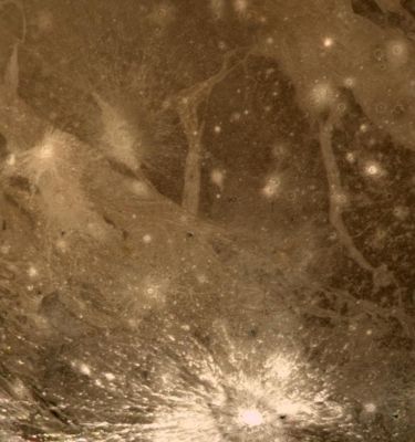 Ganymede (Enhanced Natural Colors and HR; credits: NASA/JPL)
Caption NASA originale:"This color picture of Ganymede is relevant to a Region located at 30° South Lat. and 180° West Long. It shows features as small as 6 Km (about 3,7 miles) across. Notice here a bright halo impact crater that shows the fresh material thrown out of the crater. In the background it can be seen a bright grooved terrain that may be the result of the shearing of the surface materials along fault planes. 
The dark background material is the ancient heavily cratered terrain -- probably the oldest material preserved on the surface of Ganymede".
Parole chiave: Jupiter's Moons - Ganymede