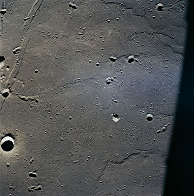 AS 11-37-5447 - Undocking (5) - Moltke Crater
Original caption:"CSM Columbia and Crater Moltke. 
This view also includes the Apollo 11 Landing Site, which is just above and to the left of Columbia".
Parole chiave: The Moon from orbit - Craters (Moltke)