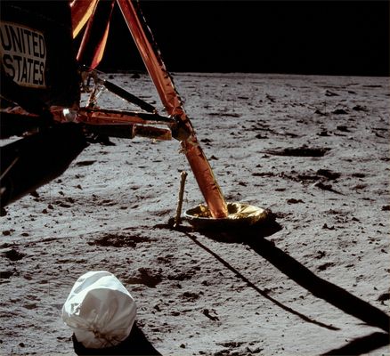 AS 11-40-5850 - The first "Moon-Shot" (HR)
Original caption:"109:30:53 MT - First EVA picture. Neil's first Pan from West of the ladder. 
Jettison bag under the Descent Stage, South footpad, bent probe, strut supports, more or less up-Sun so we are seeing the shadowed faces of boulders. 
There is a fair sized crater East-SouthEast of the footpad - probably East Crater - which Neil will visit at the end of the EVA".
Parole chiave: Lunar Module