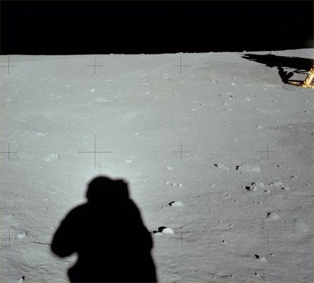 AS 11-40-5930 - Armstrong's shadow... (HR)
Original caption:"110:55:49 MT. Neil has backed away from the LM to take a panorama. This down-Sun shows the bright halo - possibly a diffraction effect - that appeared around the shadow of Neil's helmet. Note, also, how washed out the scene is along the line of his shadow. This effect is due to the fact that, in this direction, all of the shadows - excepting only those cast by objects in the immediate foreground - are hidden by the objects that cast them. In addition, there are also strong reflections off the soil particles which also contribute to the visual washout".
Parole chiave: Postcards from the Moon