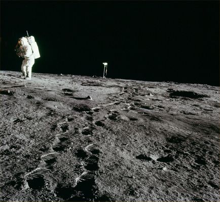 AS 12-46-6780 - Alan Bean, TV camera and deep foot-prints (HR)
Frame from Pete's 8 o'clock pan. Rightward of 6779. A good picture of Alan Bean, who is still photographing the plus-Y footpad with the TV camera in the background. Notice the line of footprints that Pete Conrad made when he came over from the location of the 4 o'clock pan. This photo gives an impresssion of the way the ground was swept by the engine exhaust. 
This is particularly evident - perhaps because of lighting - along a line from the engine bell (off-image to the left) through the probe at the left edge to the lower right corner. (...) . Scan courtesy NASA Johnson".
Parole chiave: Lunar Surface - Astronaut, boot-prints, dust and rocks