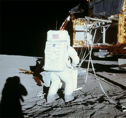 AS 12-46-6783 - Alan Bean, RTG pack and LM (HR)
Down-Sun photograph of Alan Bean, who has just removed the RTG package from the SEQ Bay. We can see the "saddlebag" he is wearing at his left hip. The saddlebag material resembles the Teflon cloth used for the Sample Collection Bags (SCBs) used on Apollos 15, 16 and 17. Note that the transmitted light in the shadow of the saddlebag has a reddish-brown color. We can see the boom on which the RTG package rode as it was pulled out of the SEQ bay. We can also see the pulleys that were operated with the tapes. The SEQ bay door that covered the right-hand 2/3rds is folded up out of the way. At the left side of the bay, we can see the vertically hinged portion of the door pulled back out of the way. Note that the SEQ bay is not an integral part of the LM structure but, rather, hangs on the outside. Below the SEQ bay, we can see a shield which protects the landing radar (mounted on the bottom of the Descent Stage) from heat radiating from the engine bell. 
Scan courtesy NASA Johnson.
Parole chiave: Lunar Module and Astronaut