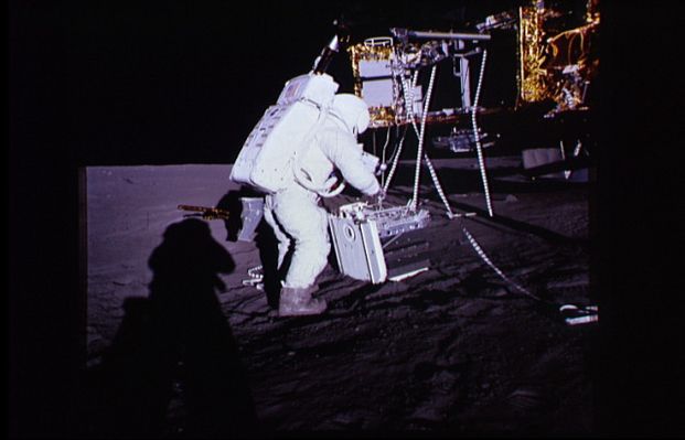 AS 12-46-6785 - The RTG Package
Caption NASA originale:"Al has placed the RTG package on the ground. Note the cooling fins on the RTG. Note the pull rings on the edge closest to Al. These pull rings are used to release 'pip pins' with which some pieces of equipment are attached to the RTG pallet. The light-colored piece of gear that is attached to the part of the RTG pallet that is on top in this picture is the SIDE (Suprathermal Ion Detection Experiment). Note the deployment rail and pulleys extending out from the SEQ bay above the upper ends of the lanyards. The distinctive ring-shaped top of the fuel cask can be seen behind the left-hand SEQ bay door. Note the saddlebag on Al's left hip and note, also, that Pete's shadow shows that he is wearing one too".
Parole chiave: Lunar equipment - RTG