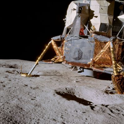 AS 14-66-9254 - The Lunar Module
Frame from Al's 4 o'clock pan. Right side and aft section of the LM, looking south. An excellent picture of the LM with many structural details are visible. The area under and slightly behind the engine bell shows evidence of disturbed soil resulting from the Descent Engine exhaust. Also visible in the crater next to the rear (-Z) footpad is the track made by the probe as it scraped across the surface. The right (+Y) footpad has dug into the soft rim of a crater, causing the LM to slide slightly. Refer, also, to AS 14-66-9269, a view of the left (-Y) footpad to see more evidence of this northward slide.
The lightweight construction of the LM is apparent in this picture. Minor buckling of panels covering the aft equipment bay and right side of the LM are visible. Notice also thermal damage done to the RCS plume deflectors. The extensive use of gold tape to secure the black insulation blankets can be seen. 
Parole chiave: LM
