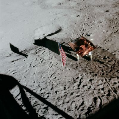 AS 14-66-9324 - A basket full of gold?!?
This frame was taken out Ed Mitchell's window between the two EVAs and shows the flag and the MET at the LM between the EVAs. Note that, in addition to parking the MET in the shadow of the S-Band antenna, as per checklist, they have put the S-Band cover on it. Good footprint and tire track definition. 
Parole chiave: Controversial image