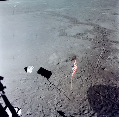AS 14-66-9338 - Flag and tracks (HR)
Ed Mitchell took this splendid picture after he and Shepard jettisoned the PLSSs in preparation for launch. Of particular interest are the tracks made by the crew and the MET during the traverse to the ALSEP deployment site and during the return to the LM. The ALSEP Central Station is about 180mt from the LM. Note the excursions the crew made around the rimless crater in the foreground and the large depression in the middle distance that they traversed in both directions. Without the visual clues provided by the tracks, the depression is not easy to pick out in this down-Sun photo. Note that the flag is now pointing on an azimuth of about 335 and undoubtedly moved from it prior pointing of about 120 as a result of the cabin depressurization done for the jettison. Journal Contributor Jim Scotti notes that we "can see the impact 'crater' and roll marks made by the PLSS farthest from the LM. It rolled on it's side and you can see a fair bit of detail in the hoses and straps on the righthand side of it".
Parole chiave: Lunar Surface - Flag, crater, equipment and tracks