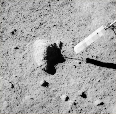 AS 15-82-11164 - Great Scott! (HR)
Original caption:"166:09:44 MT. (...) this is a "before" of sample 15555, generally known as 'Great Scott', a 9,6 Kg piece of basalt and the largest Apollo 15 sample.   
The Apollo 15 Photographic Index incorrectly indicates that this picture was taken at Station 10. 
Scan courtesy NASA Johnson".

Parole chiave: Lunar Surface - Rocks, sand and dust