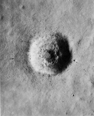 AS 15-9287 - A "Middle-aged" Crater
Remarkable detail is shown in this enlargement of a small part of a panoramic camera frame. In most respects, the crater itself is typical of a great many craters its size-about 1,2 Km. Because it does not have rays, it is believed to be older than most other Lunar craters. Its rounded rim crest and slightly raised rim (extending outward to the arrow, on the West side) also point to its greater age. On the other hand, it is young enough that some of the original dunelike texture of the ejecta blanket is preserved (especially to the West), a great many large blocks of ejecta are still visible, and the original depth of the crater has not been greatly lessened by infalling debris. The largest blocks, which are about 30 mt in size, occur near the rim. The terrace (T) extending partly around the wall about 100 mt below the surface probably marks the top of a resistant rock layer. However, if there were other signs of bedrock stratification within this crater, they have been obscured by the movement of debris down the walls. The very smooth floor is the only unusual feature of this crater. It may consist of a solidified pool of rock melted by heat generated from the impact.
Parole chiave: The Moon from orbit - Craters - Unnamed Crater