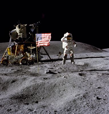 AS 16-113-18339 - A "Postcard from the Moon"
John Young jumps off the ground and salutes for this superb tourist picture. He is off the ground about 1.45 seconds which, in the lunar gravity field, means that he launched himself at a velocity of about 1.17 m/s and reached a maximum height of 0.42 m. Although the suit and backpack weigh as much as he does, his total weight is only about 65 pounds (30 kg) and, to get this height, he only had to bend his knees slightly and then push up with his legs. In the background, we can see the UV astronomy camera, the flag, the LM, the Rover with the TV camera watching John, and Stone Mountain. 
Parole chiave: Postcards from the Moon