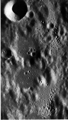 AS 16-4653 - Secondary Craters' Clusters
These 3 clusters of secondary craters (see arrows) are on the East flank of the larger crater Ptolemaeus near the center of the Moon's Near-Side. Each cluster has a ridged and hummocky appearance. The primary crater has not been identified in this case, but the configuration of the clusters tells us that it must be to the South of Ptolemaeus. Note that the South-facing side of each cluster is more sharply defined than the North-facing side. 
This is a consequence of the oblique trajectory of impacting fragments that causes the ejecta of the secondary craters to be propelled away (down range) from the primary crater. Observations of manmade impact craters have shown that the individual fragments within a cluster of secondary debris strike the surface nearly simultaneously. 
In the process, ejecta from one secondary collides and interferes with ejecta from adjacent craters, producing a ridged and hummocky surface.
Parole chiave: The Moon from orbit - Secondary Craters