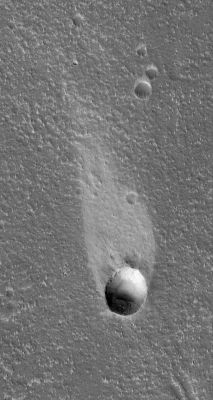 Windstreak in Cyane Fossae
Caption NASA originale:"This MGS-MOC image shows a light-toned wind streak created in the lee — such as the downwind side — of an impact crater in the Cyane Fossae Region of Mars. Winds blowing from the bottom (South) toward the top (North) swept this scene clean of fine, bright dust except for the dust that had accumulated in a few protected areas such as that in the lee of this crater". 

Location near: 42,0° North; 125,8° West
Image width: ~3 Km (~1,9 mi)  
Illumination from: lower left  
Season: Northern Spring
Parole chiave: Mars from orbit - Windstreaks