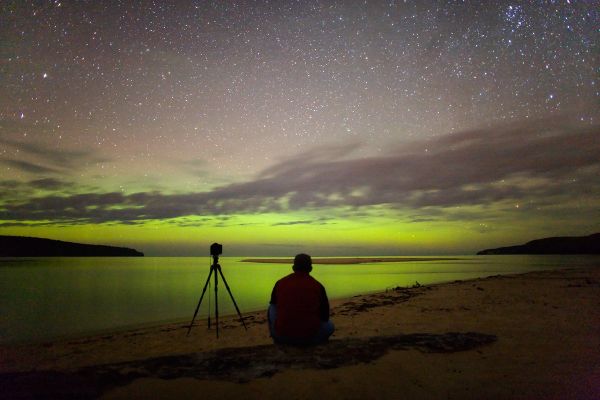 Green Aurora
Da "NASA - Picture of the Day" del 6 Settembre 2006:"What if your horizon was green? If you've got a camera, take a picture! That was the experience of Jeff Hapeman last week when visiting the Pictured Rocks National Lakeshore in Michigan. On a quiet night toward the Northern Horizon over Lake Superior was a long lasting diffuse green aurora. The above image was taken in an effort to capture the sense of wonder one gets when watching an auroral display. Auroras are sparked by energetic particles from the Sun impacting the magnetic environment around the Earth. Resultant energetic particles such as electrons and protons rain down near the Earth's poles and impact the air. The impacted air molecules temporarily lose electrons and when oxygen molecules among them reacquire these electrons, they emit green light. Auroras are known to have many shapes and colors".
Parole chiave: Artistic Pictures