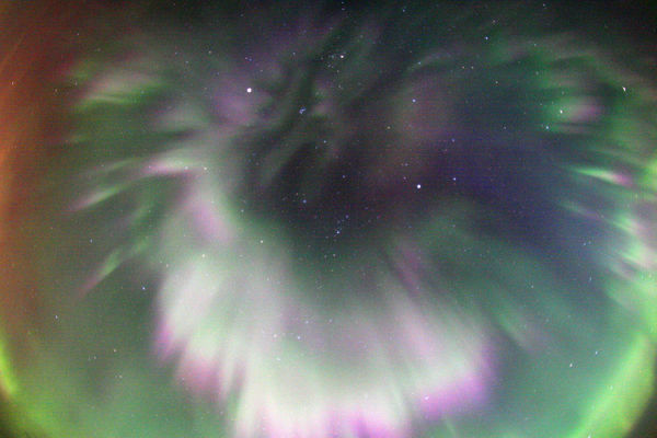 Northern Lights over Canada
So far, the Aurora Borealis - or "Northern Lights" - have made some remarkable visits to September's Skies. The reason, of course, is the not-so-quiet Sun. In particular, a large solar active region now crossing the Sun's disk has produced multiple, intense flares and a large Coronal Mass Ejection (CME) that triggered wide spread auroral activity just last weekend. This colorful example of spectacular curtains of aurora was captured with a fish-eye lens in skies over Quebec, Canada, on September 11, 2005. 
Also featured is the planet Mars, the brightest object above and left center. Seen near Mars (just below and to the right) is the tightly knit Pleiades star cluster. 
Although they can appear to be quite close, the Northern Lights actually originate at extreme altitudes, 100 Km or so above the Earth's surface.
Parole chiave: Aurora Borealis