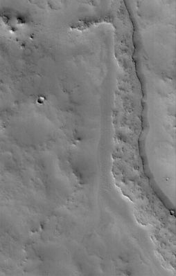 Inverted channels of Arabia Terra (2 - Original NASA/MGS/MSSS b/w Frame)
Original caption:"This MGS-MOC image shows a somewhat sinuous, nearly flat-topped Ridge, located in Eastern Arabia Terra. The ridgetop was once the Floor of a Valley, perhaps carved by running water. The Valley Floor, or material that covered the Floor, was more resistant to erosion than the surrounding rock into which the Valley was cut. Thus, over time, the Valley disappeared and its Floor was left standing high as a Ridge. Inverted Valleys are common on Mars, but they also occur on Earth". 

Location near: 10,8° North Lat. and 313,2° West Long.
Image width: width: ~3 Km (~1,9 mi)
Illumination from: lower left 
Season: Northern Winter
Parole chiave: Mars from orbit - Channels - Inverted Channels