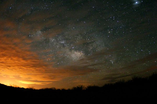 Clouds and Clouds
The clouds in the foreground are much different than the clouds in the background. In the foreground are a photogenic deck of Earth-based water clouds. The long exposure used to create the above photograph makes the light from the left, reflected from Phoenix, Arizona, USA, appear like a sunset. Far in the distance, however, are star clouds from the disk of our Milky Way Galaxy. Billions of stars like our Sun live there, circling our Galactic center every 200 million years. Contrast between the water clouds and the star clouds has been digitally enhanced. Between the two, visible on the upper right, is the planet Jupiter.
Parole chiave: Amatorial Pictures