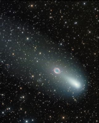 Comet Schwassmann-Wachmann 3 and M 57
Moving rapidly through planet Earth's night sky, Fragment "C" of crumbling comet 73P/Schwassmann-Wachmann 3 passed almost directly in front of M 57 - the "Ring Nebula" - and faint spiral galaxy IC 1296 on May 8, 2006. In fact, in this gorgeous view, the bright head of mentioned Fragment "C" is separated by only about 0,1° from M 57, with the tail apparently engulfing nebula and galaxy. 
Recorded from Elizabeth, Illinois, USA, this picture corresponds to the cosmic scene only 30 minutes after yesterday's picture of the approaching alignment. The relative motion of the comet against the background stars and nebulae is easy to see when comparing the two images. This comet's fragments will be near their closest approach in the coming days, about 10 MKM away, and none pose any danger to our fair planet.
Parole chiave: Amatorial Pictures