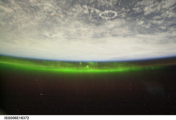 Coronal Aurora from Space
Original caption:"From the ground, spectacular auroras seem to dance high above. But the International Space Station (ISS) orbits at nearly the same height as many auroras, sometimes passing over them, and sometimes right through them. Still, the auroral electron and proton streams pose no direct danger to the ISS. In 2003, ISS Science Officer Don Pettit captured the green aurora, pictured above in a digitally sharpened image. From orbit, Pettit reported that changing auroras appeared to crawl around like giant green amoebas. Over 300 Km below, the Manicouagan Impact Crater can be seen in northern Canada, planet Earth".
Parole chiave: Coronal Aurorae