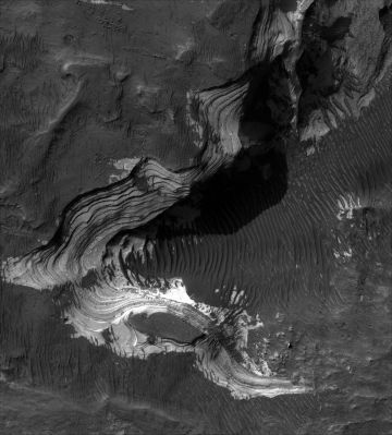 The beautiful Holden Crater
This HiRISE image covers a portion of the floor of Holden Crater situated in southwest Margaritifer Terra. Holden crater has likely experienced extensive modification by running water, which is supported by observations of drainage and deposition into the crater from a large channel breaching Holden's rim and the alluvial fans that built out along the floor of the crater. The HiRISE sub-image shows relatively bright finely layered deposits that are capped by relatively darker materials. Unlike previous images, the HiRISE image shows that the thickness of some of the individual layers are on the order of a meter or even less in thickness and are laterally uniform and continuous over the extent of the imaged outcrop. Some of the layers in the outcrop display an orthogonal pattern or what may be fractures or joints. The "layer-cake" appearance of these layers suggests that they may have been deposited into a lake that once occupied the crater floor and have seen little in the way of deformation since that time. By contrast, the darker materials overlying the layers are younger and may have been sediments deposited off the nearby alluvial fans. Alternatively, they may represent wind-blown deposits lain down during a later much drier period similar to the conditions that currently exist at the surface today. In some locations, the darker materials have been stripped and expose the lighter finely layered sediments underneath, thereby implying the finely layered materials extend much farther than what is visible along the large outcrop.
Parole chiave: Mars from orbit - Craters - Holden Crater