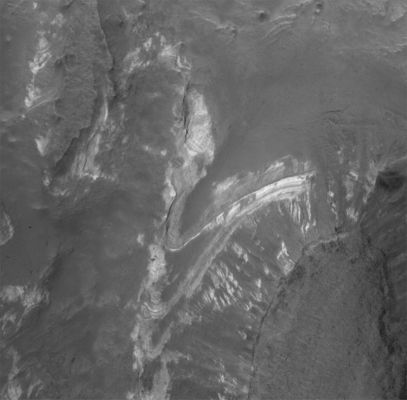 The Sedimentary Layers of Terby Crater (1 - Original NASA/MGS/MSSS b/w Frame)
Original caption:"This MGS-MOC image shows some of the light-toned, layered, Sedimentary Rock Outcrops in Northern Terby Crater. Terby is located along the North edge of Hellas Planitia. The Sedimentary Rocks might have been deposited in a greater, Hellas-filling sea — or not. Today, the rocks are partly covered by dark-toned Sediment and Debris".

Location near: 27,2° South Lat. and 285,3° West Long.  
Image width: ~3 km (~1,9 mi)  
Illumination from: upper left  
Season: Southern Summer
Parole chiave: Mars from orbit - Craters - Terby Crater