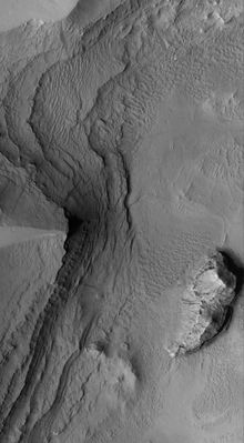 Sedimentary Rocks inside Tikhonravov Crater - Arabia Terra (Original NASA/MGS/MSSS b/w Frame)
Caption NASA originale:"This MGS-MOC image shows Layered Sedimentary Rocks exposed by erosion, then mantled by Dust, in Tikhonravov Crater in central Arabia Terra. Dark Slope Streaks occur where some of the Dust has slid down the layered Slopes".

Location near: 13,8° North Lat. and 324,8° West Long.
Image width: ~3 Km (~1,9 mi) 
Illumination from: lower left 
Season: Northern Autumn
Parole chiave: Mars from orbit - Craters - Tikhonravov Crater