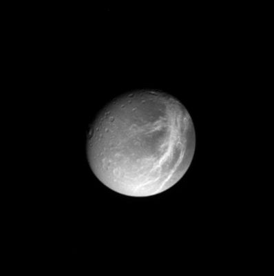 Dione from approx. 1.200.000 Km
A gorgeous Dione poses for Cassini, with shadowed craters and bright, wispy streaks first observed by the Voyager spacecraft 24 years ago. The wispy areas will be imaged at higher resolution in mid-December 2004. Subtle variations in brightness across the surface of this moon are visible here as well. Dione's diameter is 1.118 Km. The image shows primarily the trailing hemisphere of Dione, which is the side opposite the moon's direction of motion in its orbit. The image has been rotated so that north is up. 
The image was taken in visible light with the Cassini spacecraft narrow angle camera on Oct. 27, 2004, at a distance of about 1.2 MKMs from Dione and at a Sun-Dione-spacecraft, or phase, angle of 28°. The image scale is 3.5 Km per pixel. 
Parole chiave: Saturn's Moons - Dione