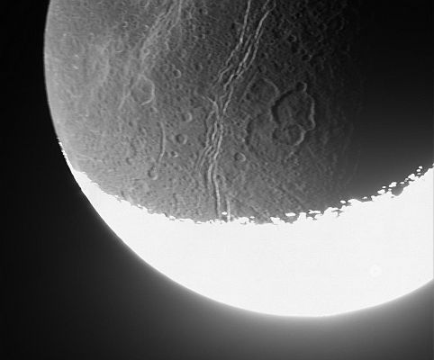 The Night-Side of Dione, in the Saturnshine
Caption NASA originale:"Cassini whizzed past Dione on Aug. 16, 2006, capturing this slightly motion-blurred view of the moon's fractured and broken landscape in reflected light from Saturn. The motion blur is a result of the long exposure time used to capture dim light from the moon's night side. 
The many canyons on Dione rip through more ancient craters. Some medium-sized craters, like the one right of center, have several others overprinted onto them. This view shows southern terrain on the moon's Trailing Hemisphere. The gleaming, sunlit crescent is overexposed at bottom. North is up. 

The image was taken in visible light with the Cassini spacecraft narrow-angle camera at a distance of approx. 157.000 Km (about 98.000 miles) from Dione and at a Sun-Dione-spacecraft angle of 129°. 
Image scale is about 935 mt (roughly 3.067 feet) per pixel".
Parole chiave: Saturn's Moons - Dione