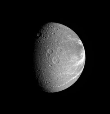 The "wrinkled Face" of Dione
Caption NASA:"Bright fractures creep across the surface of icy Dione. This extensive canyon system is centered on a region of terrain that is significantly darker than the rest of the moon. Part of the darker terrain is visible at right. 
Lit terrain in this view is on the Saturn-Facing Hemisphere of Dione. 
North is up and rotated 8° to the left. 

The image was taken in visible light with the Cassini spacecraft narrow-angle camera on Sept. 25, 2006 at a distance of approx. 677.000 Km (such as 421.000 miles) from Dione and at a Sun-Dione-spacecraft, or phase, angle of 62°. 
Image scale is roughly 4 Km (about 2,5 miles) per pixel".
Parole chiave: Saturn's Moons - Dione