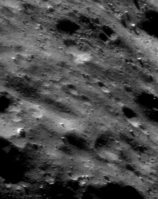 Eros from above (2)
NEAR Shoemaker photographed this area of Eros on December 18, 2000, from an orbital altitude of 33 Km. This part of the asteroid's surface, like many others, appears vaguely "sculptured" due to its low, elongated ridges and depressions with seemingly consistent orientations. Some of the low spots also contain accumulations of smooth, pond-like materials. Neither the surface sculpturing nor the pond-like materials are well understood, and both will be investigated in detail using even higher-resolution images from NEAR Shoemaker's low passes over Eros in early 2001. The whole scene is about 1 Km across.
Parole chiave: Asteroids: images from Space