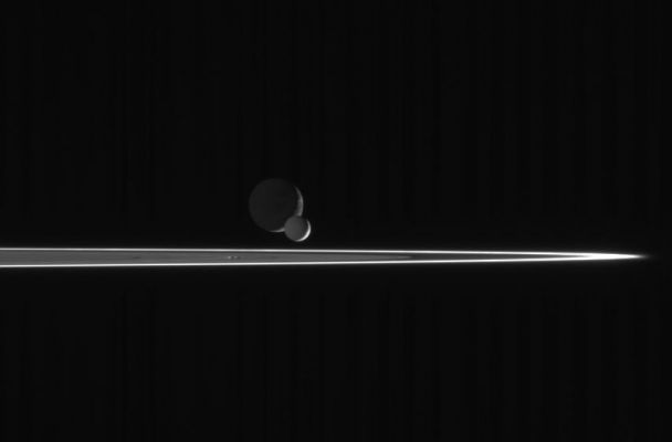 Crowded Saturnian Skies...
As our robotic emissary to Saturn, the Cassini spacecraft is privileged to behold such fantastic sights as this pairing of two moons beyond the Rings. The bright, narrow F-Ring is the outermost ring structure seen here. 
In this scene, bright Enceladus begins to slip in front of more distant Dione. Enceladus is closer to Saturn than Dione, and orbits the planet at greater velocity. Thus, the smaller moon eventually passed the larger one, as seen from the Cassini spacecraft, and continued on its way. 

The image was taken with the Cassini spacecraft narrow-angle camera on March 3, 2006, using a filter sensitive to wavelengths of ultraviolet light centered at 338 nnmts and at a distance of approx. 2,6 MKM (about 1,6 MMs) from Enceladus and 2,7 MKM (such as about 1,7 MMs) from Dione. The view was taken from a phase angle (Sun-moon-spacecraft angle) of 139°; about the same angle with respect to both moons. Image scale is about 16 Km (roughly 10 miles) per pixel on Enceladus and Dione.
Parole chiave: Saturn's Moons - Dione and Enceladus