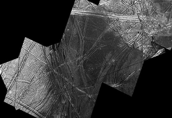 Dark Region on Europa
This view taken by NASA's Galileo spacecraft of Jupiter's icy moon Europa focuses on a dark, smooth Region whose center is the lowest area in this image. To the West (left), it is bounded by a cliff and terraces, which might have been formed by normal faulting. The slopes toward the East (right) leading into the dark spot are gentle. Near the center of the dark area, it appears the dark materials have covered some of the bright terrain and ridges. This suggests that when the dark material was deposited, it may have been a fluid or an icy slush. Only a few impact craters are visible, with some of them covered or flooded by dark material. Some appear in groups, which may indicate that they are secondary craters formed by debris excavated during a larger impact event. A potential source for these is the nearby crater Mannann`an.
North is to the top of the picture which is centered at 1° South Latitude and 225° West Longitude. The images in this mosaic have been re-projected to 50 mt/pixel. 
Parole chiave: Jupiter Moons - Europa