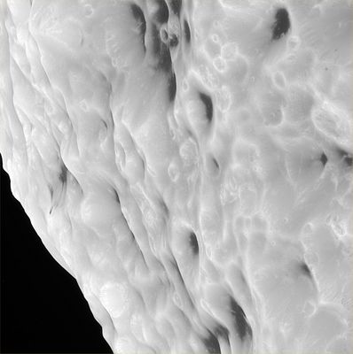 Hyperion's unusual craters (1) - HR
Original caption:"This HR Cassini mosaic shows that Hyperion truly has a surface different from any other in the Saturn System. The mosaic is composed of 5 clear filter images taken during Cassini's close flyby of Hyperion on Sept. 26, 2005. The spacecraft passed approximately 500 Km(310 miles) above the moon's surface. Hyperion is 266 Km (about 165 miles) in diameter. 
Scientists are extremely curious to learn what the dark material is that fills many craters on this oddball moon. Features within the dark terrain, including a 200-meter-wide impact crater surrounded by rays to the right of center (Sezione 3 del frame) and numerous bright-rimmed craters, indicate that the dark material may be only tens of meters (hundreds of feet) thick with brighter material beneath".
Parole chiave: Saturn's Moons - Hyperion