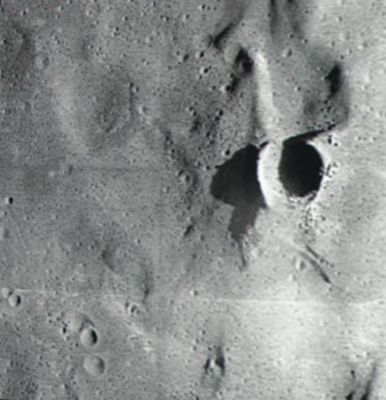 Blue Flares and the Invisible Crater: Cone Crater
In soccorso ci viene il fotogramma S70-49764 scattato il 12 Gennaio 1970 con obbiettivo 120mm - b/w - dallo stesso Apollo 14. 
Mi limito a far notare come l’ombra del bordo occidentale si estenda per oltre 200 mt e, dato che sappiamo che l’ombra di quello orientale corrisponde ad un dislivello di circa 100 mt rispetto al fondo del Cone Crater, non ci vuole molto a stimare in diverse decine di metri l’altezza dell’orlo incriminato. In questo dettaglio è possibile stimare meglio le proporzioni ed i particolari del cratere: tutti elementi di cui, nelle foto panoramiche riprese "from the surface", non si trova alcuna traccia.
Parole chiave: A Moon Investigation