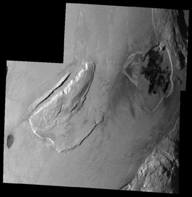 Shamshu Mons and Patera from 34.500 Km
This mosaic of images taken by NASA's Galileo spacecraft on February 22, 2000 shows 3 mountains and two lava-filled depressions in the Shamshu Region of Io. The dark oval feature on the left side is a depression that has been resurfaced by lava flows. The rough terrain North-East of the depression is Shamshu Mons. A 10-Km (6-mile) wide canyon oriented in North-East to South-West direction cuts this mountain. The northwestern edge of the mountain has been scalloped by erosion and it appears that the material has flowed along the canyon floor. Portions of 2 more mountains can be seen on the right side. The depression between these mountains is Shamshu Patera, a volcanic hotspot. The dark patches within it are recent and active lava flows. The northernmost edge of Shamshu Patera appears to be cutting into the mountain to its northeast. North is to the top of the picture and the Sun illuminates the surface from the West. This mosaic has a resolution of about 345 mt/pixel and covers an area of about 390x380 Km.
Parole chiave: Jupiter Moons - Io