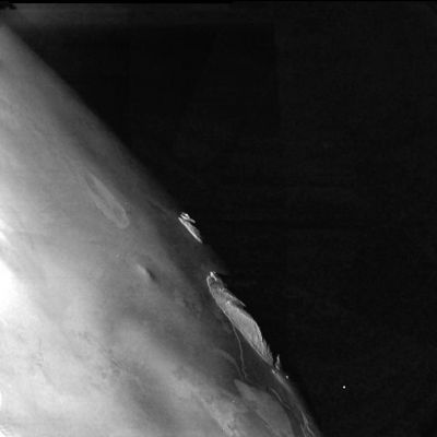 The Southern Limb of Io and a possible "Transient Phoenomenon"
Un'immagine interessantissima del bordo dell'emisfero sud di Io. Elevatissimo dettaglio e grande suggestione del paesaggio. Io è un mondo violento ed in costante tumulto: il numero di vulcani attivi su questo Pianeta è elevatissimo (gli ultimi dati in nostro possesso parlavano di 6 vulcani attivi contemporaneamente), dunque non ci meravigliamo se vediamo delle flares, come quella alla Dx di questo frame, splendere nel buio. Potrebbe trattarsi di un outgassing: un classico fenomeno transitorio. 
Original caption:"NASA's Galileo spacecraft captured this dramatic image of mountains on Io in February 2000. The image was taken when the Sun was low in the sky, illuminating the scene from the left, so it reveals topographic details of Io's surface. A low scarp, roughly 250 meters (820 feet) high, runs from the upper left toward the center of the image. Mongibello Mons, the jagged ridge at the left of the image, rises 7 kilometers (23,000 feet) above the plains of Io, higher than any mountain in North America. Few of Io's mountains (see also PIA02526) resemble volcanoes. Instead, Galileo scientists believe that the mountains are formed when blocks of Io's crust are uplifted along thrust faults. Angular mountains are thought to be younger, while older mountains have more subdued topography, such as the rise near the top center of this image.

The image has a resolution of 335 meters (1,100 feet) per picture element. North is to the top of the image.


Parole chiave: Jupiter's moons - Io